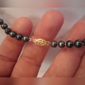 14K clasp. Magnificent “peacock” pearl necklace mounted on white thread tied bet